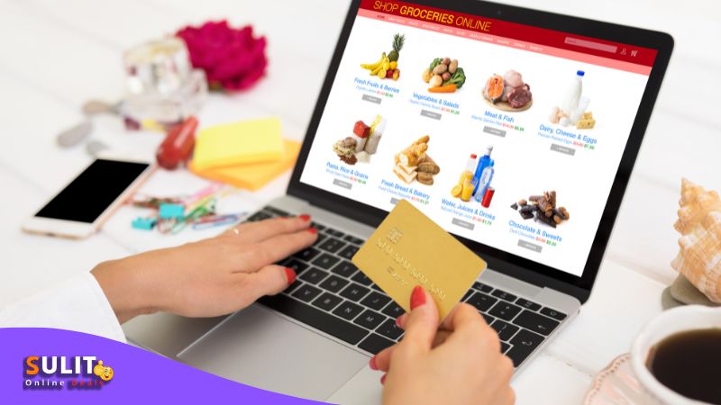 A woman is shopping online with a credit card.
